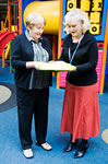 Margaret Kennett delivering the books to Sandy Keane at Adelaide Hospital